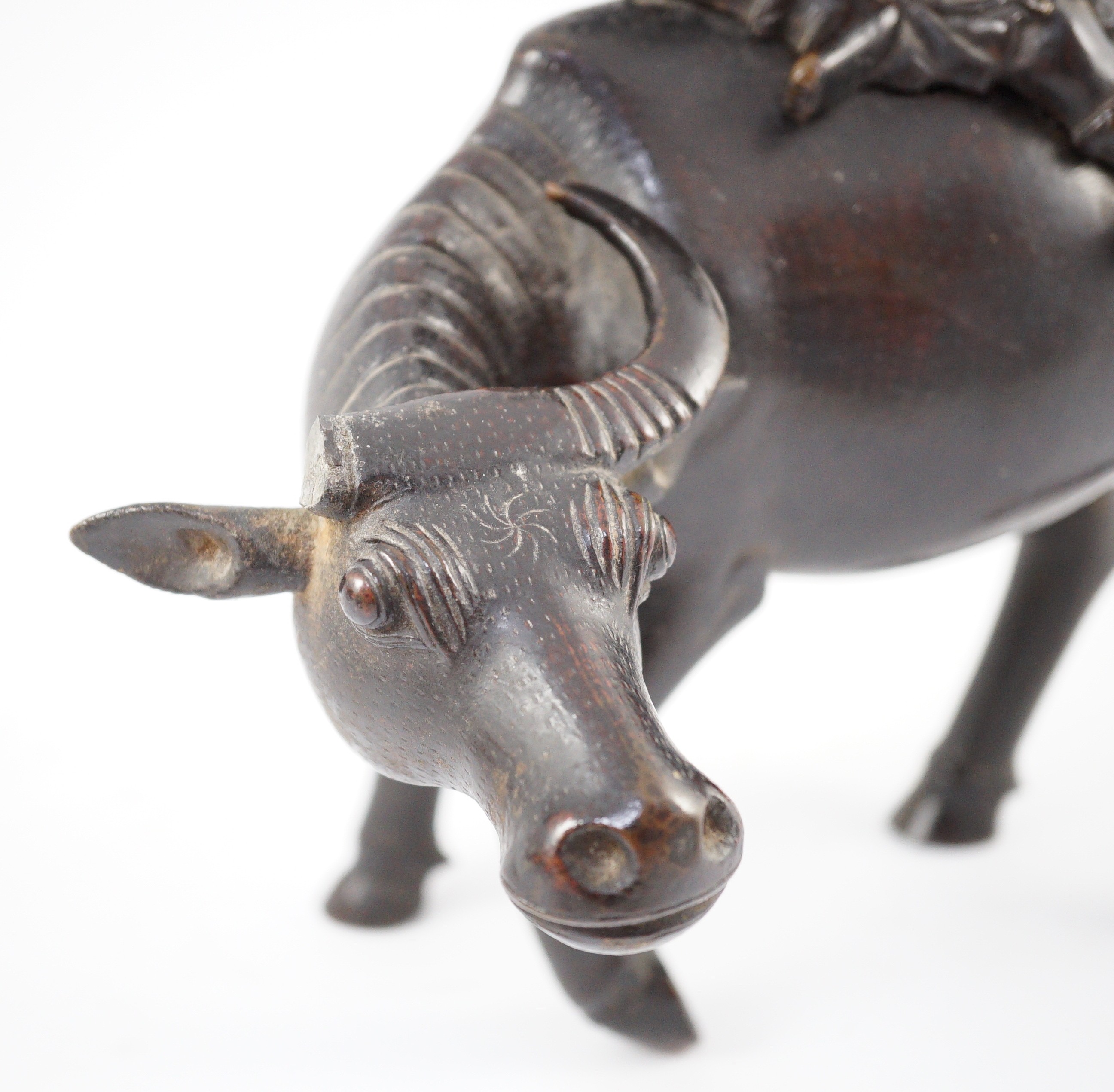 A Chinese bronze ‘boy riding a water buffalo’ censer, 17th/18th century, 22.5cm long, one horn detached but present